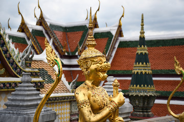Beautifully stunning gold statue of a Kinnara, a beloved mythical half-human, half-bird creature on the Upper Terrace of Wat Phra Kaew or Temple of the Emerald Buddha in the Grand Palace in Bangkok