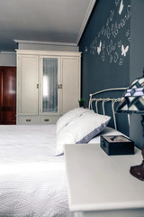 Elegant furnished double bedroom with bed, bedside table and closet