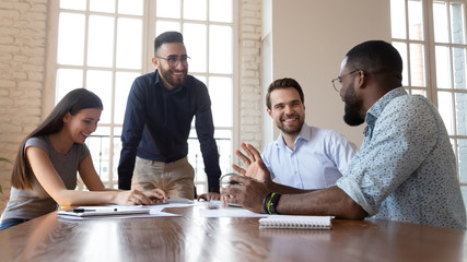 Joyful multiracial business people partners having fun during break time.