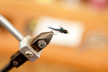 A closeup image of a freshly tied fly (fishing lure).