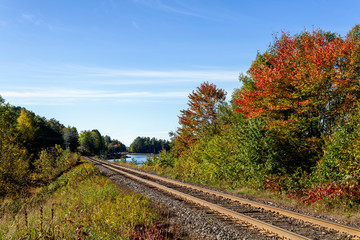 Obraz premium Railway tracks in a rural scene in nice autumn sunny day