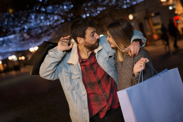 Young couple outside with shopping bags