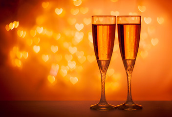two glasses of champagne on black background
