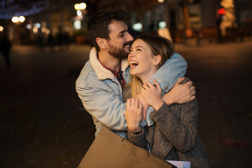 Young couple outside with shopping bags