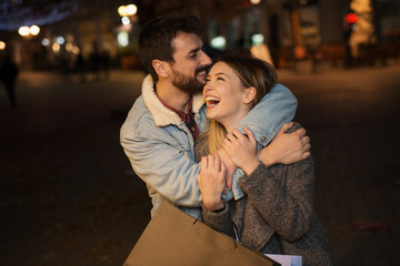 Fototapeta premium Young couple outside with shopping bags