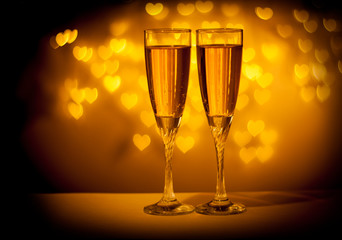 two glasses of champagne on red background