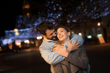 Young couple outside with shopping bags