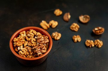 Walnuts. Kernels and whole nuts on a stone background