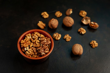 Walnuts. Kernels and whole nuts on a stone background