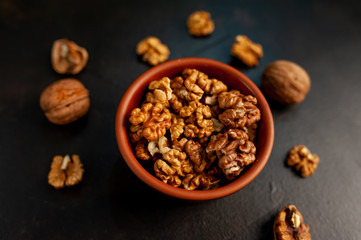 Walnuts. Kernels and whole nuts on a stone background
