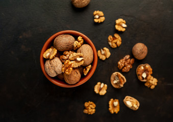 Fototapeta na wymiar Walnuts. Kernels and whole nuts on a stone background