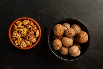 Walnuts. Kernels and whole nuts on a stone background