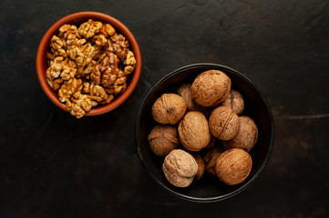 Walnuts. Kernels and whole nuts on a stone background