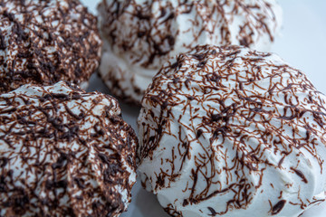Marshmallows with chocolate. Close-up. Sweet background.