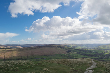 A Walker in the Peak District as the weather turns and the dark clouds roll in, Derbyshire