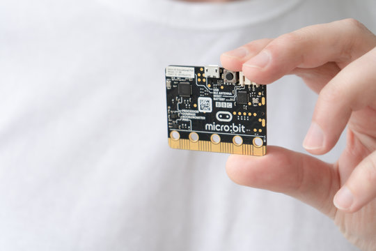 Minsk, Belarus. November, 2019. Teenager boy hold the BBC robot Micro Bit. He like it. It can be programming on Scratch and Python. Creative. Connected. Coding. Learning, teaching easy and fun. 
