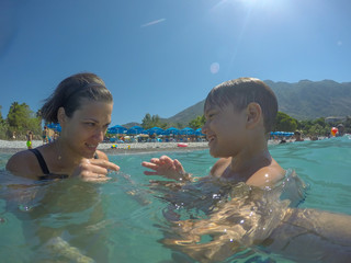 Mother and son look each other playing in the sea at Kalamata,greece