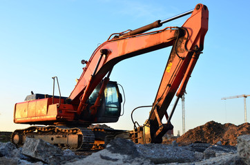 Crawler excavator with hydraulic hammer for the destruction of concrete and hard rock at the construction site. Replacing a concrete runway or road surface at an airport. Roadworks background - Image