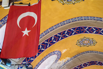 Istanbul: turkish flag and ceiling decorations inside the Grand Bazaar, one of the largest and...