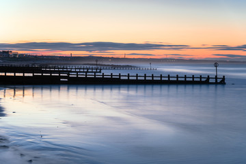 Long exposure of beach with groynes at twilight. Aberdeen, Scotland, UK.