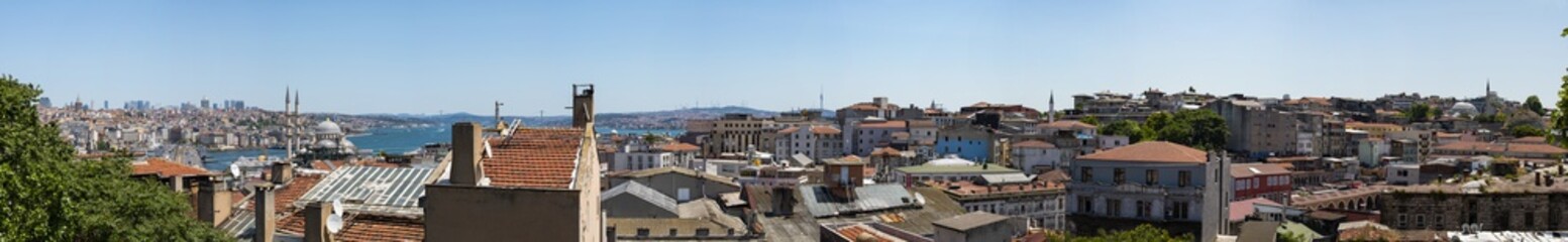 Fototapeta na wymiar Istanbul, Turkey, Middle East: a breathtaking and panoramic view of the skyline of the city with its roofs, mosques, minarets and the Bosphorus, the Strait of Istanbul, seen from the Bazaar District 