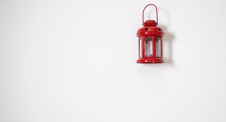 small red lamp hanging on a white wall background simple wallpaper pattern minimalism interior decoration object, copy space 