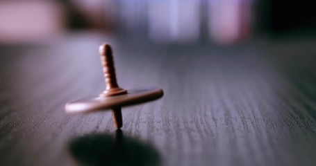 Whirligig top spinning over table