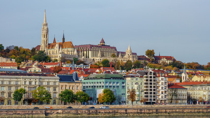 Fototapeta na wymiar Gorgeous Buda castle in Buda side of city over colorful buildings and Danube river embankment on clear day with blue skies in Budapest, Hungary. Travel landmarks and landscapes concept