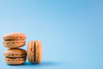 Macaroons on turquoise background top, colorful macaroons, selective focus