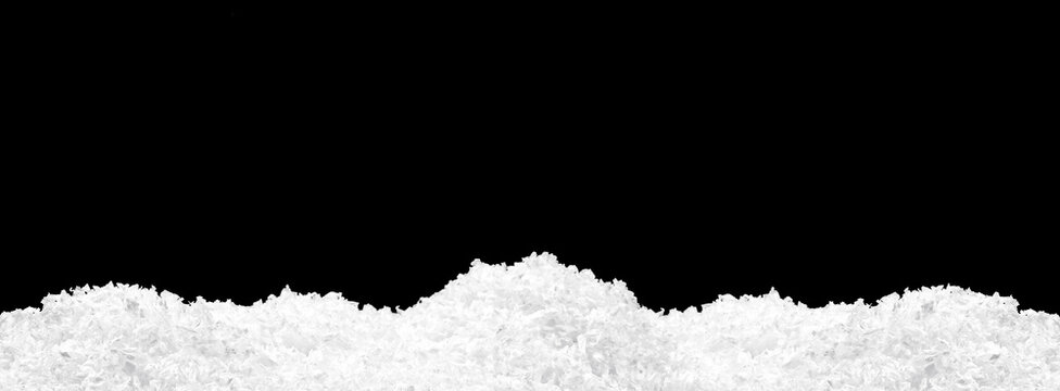 Pile of fluffy white snow isolated on pure black background
