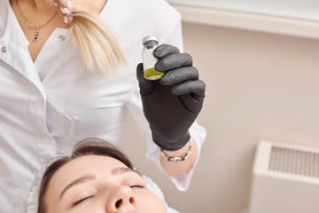 Woman gets injection in her face. Beauty woman giving beauty injections. Young woman gets beauty...