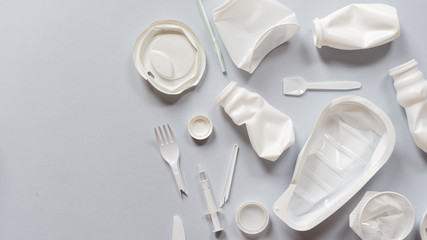 Used white plastic packaging for food on a gray background