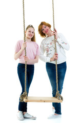 Mom and daughter swinging on a swing.