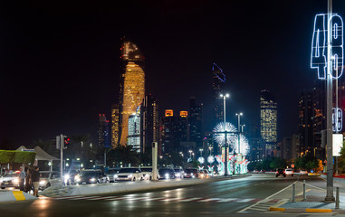 Fototapeta na wymiar Abu Dhabi downtown Corniche road decorated for the UAE national day celebration at night
