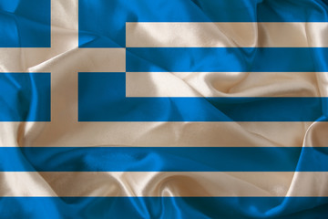 beautiful photo of the colored national flag of the modern state of Greece on textured fabric, concept of tourism, emigration, economics and politics, close up