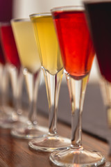 Set of glasses with different colored tinctures made on the basis of fruits and alcohol, a wonderful aperitif before the festive dinner