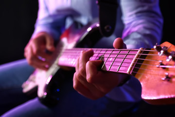 Man playing guitar, closeup view