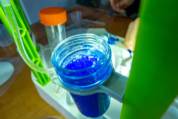 Test tube with blue bubbling liquid in the laboratory
