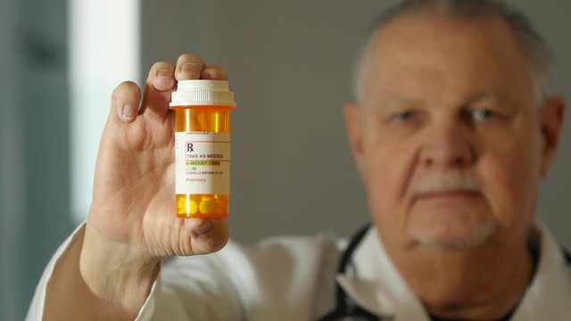 Doctor holding a prescription pill bottle