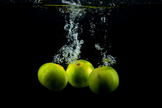 three tangerines in the water