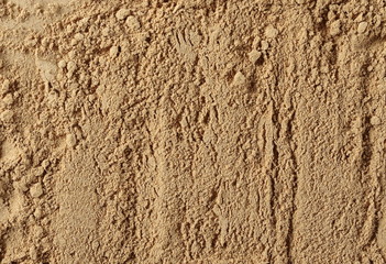 Ginger powder background and texture, top view