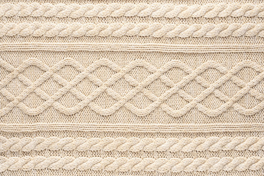 Beige Knitwear Fabric Texture with Pigtails. Beige Knitted Background.