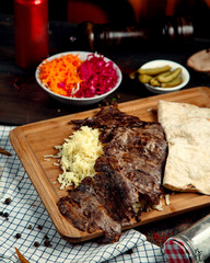 meat doner with rice and lavash on wooden board