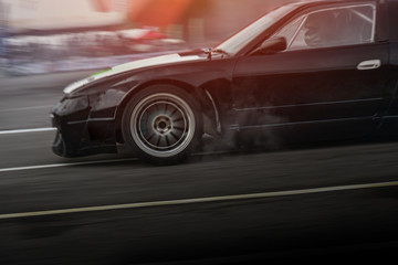Fototapeta na wymiar Sport car wheel drifting. Blurred of image diffusion race drift car