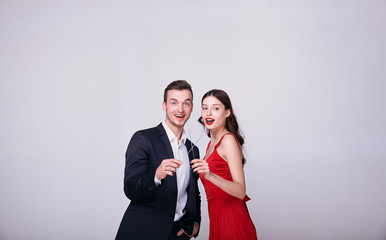 A couple at a New Years party lights sparklers.