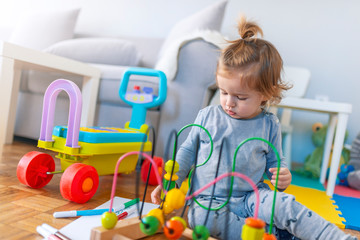 Baby boy playing with toy. Cute little boy is playing with toy. Early learning.  Small toddler or a...