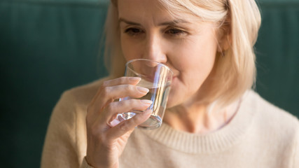 Close up of elderly woman drinking still water