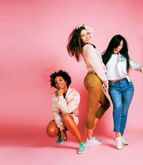 different nation girls with diversuty in skin, hair. Asian, scandinavian, african american cheerful emotional posing on pink background, woman day celebration, lifestyle people concept