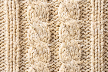 Beige Knitwear Fabric Texture with Pigtails. Beige Knitted Background.