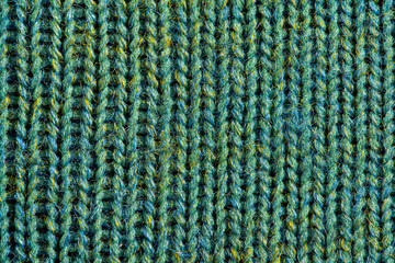 Green knitting wool texture. Cloth background close up
